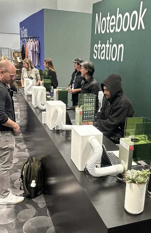 Laser engraving stations personalizing notebooks at a conference activation