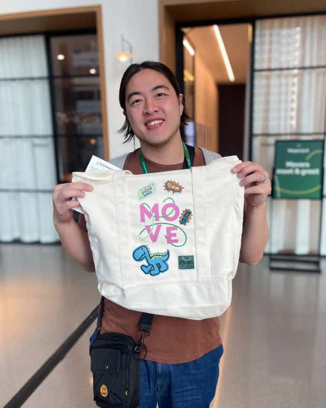 Guest holding a custom printed tote made on site